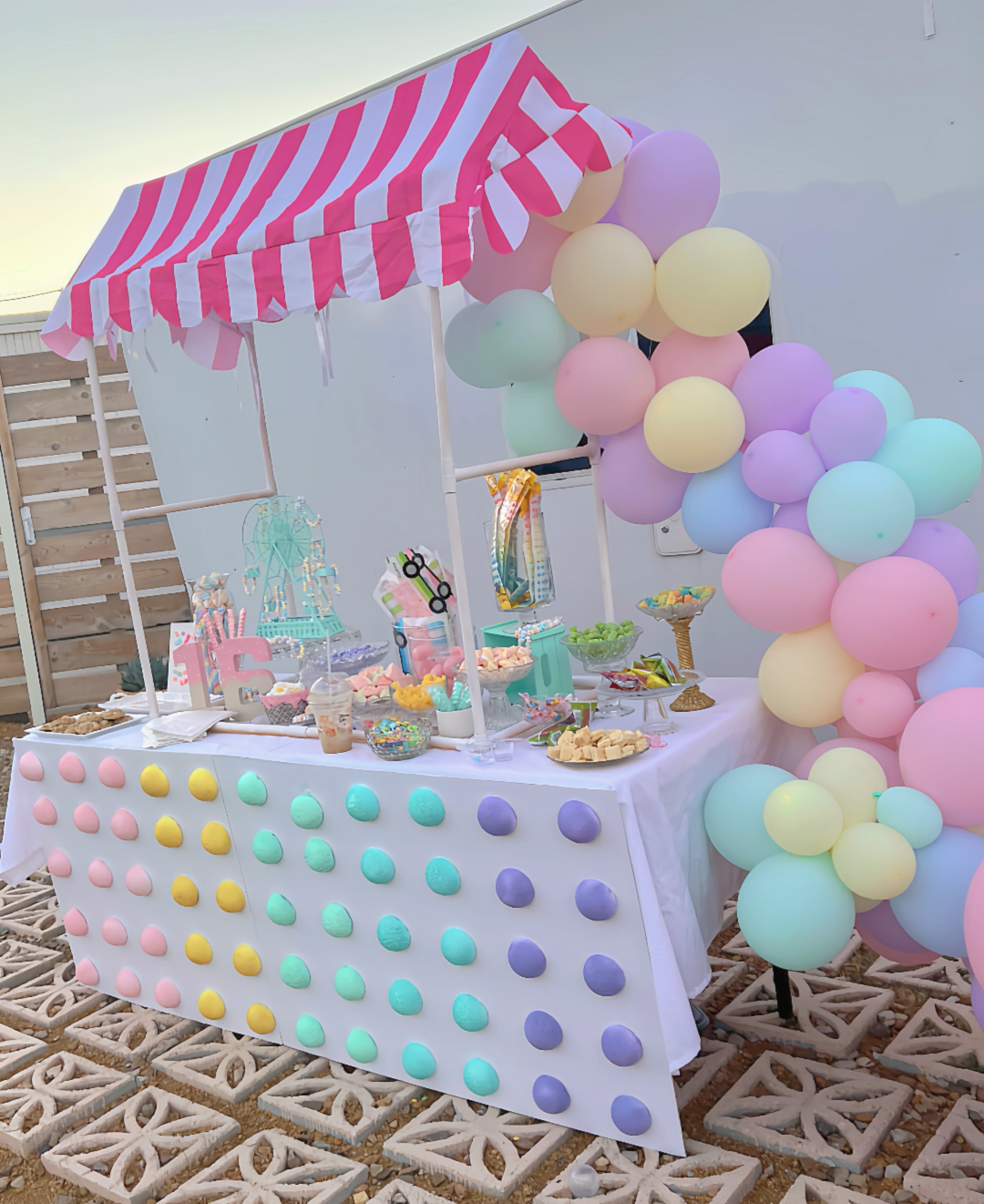 Colorful party booth with balloon arch